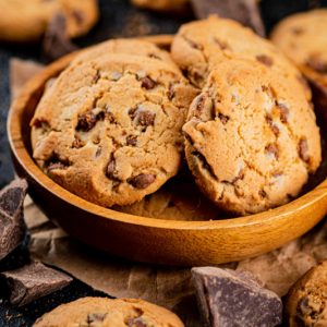 Delicious cookies with pieces of milk chocolate on a plate.